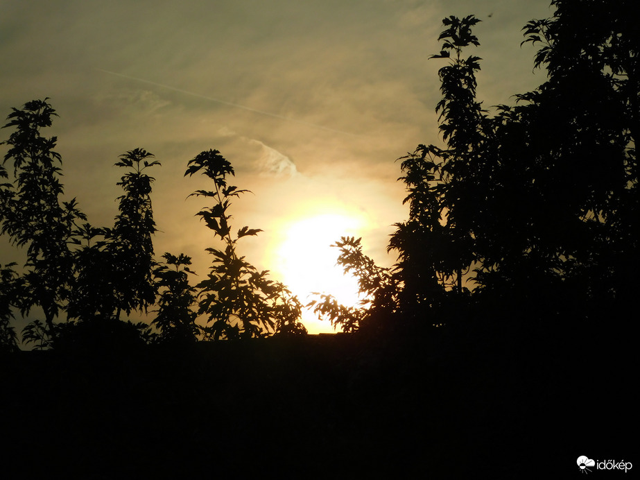 Lemenő Nap a szemben lévő ház fölött